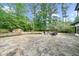 Spacious stone patio with outdoor seating area surrounded by lush greenery and a water feature at 1887 Chedworth Ct, Stone Mountain, GA 30087