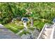 A bird's eye view showcases a pool and lush, manicured backyard surrounded by mature trees and stone patio at 3382 Habersham Rd, Atlanta, GA 30305