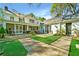 Lovely home exterior showcasing a stone patio, white brick, screened in porch, and manicured lawn at 3382 Habersham Rd, Atlanta, GA 30305