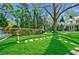 Green backyard featuring stepping stones, lawn and manicured garden spaces and mature shade trees at 3382 Habersham Rd, Atlanta, GA 30305