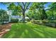 Expansive green backyard with mature trees, and lush landscaping surrounding the property at 3382 Habersham Rd, Atlanta, GA 30305