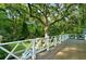 Large balcony with white railing offering a glimpse of the manicured backyard at 3382 Habersham Rd, Atlanta, GA 30305