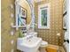 Powder room featuring designer wallpaper, white fixtures, and unique decor at 3382 Habersham Rd, Atlanta, GA 30305