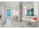 Bright bathroom with dual sinks, white marble finishes, and a large window view to the outdoors at 3382 Habersham Rd, Atlanta, GA 30305