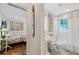 Bright bedroom near a bathroom featuring pedestal sink, black and white tile, and large window at 3382 Habersham Rd, Atlanta, GA 30305