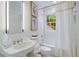 Bathroom featuring a combination tub and shower with classic white tile and elegant fixtures at 3382 Habersham Rd, Atlanta, GA 30305