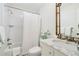 Clean bathroom with marble countertop, white tiling, and a combined bath and shower at 3382 Habersham Rd, Atlanta, GA 30305