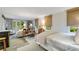 A bedroom with a bed, desk, and white chair in a light-filled space at 3382 Habersham Rd, Atlanta, GA 30305
