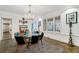 Elegant dining room featuring a chandelier, and a striking leopard print rug enhancing the sophisticated ambiance at 3382 Habersham Rd, Atlanta, GA 30305