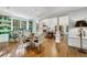 Elegant dining room featuring a hardwood floor, columns, a dining table, and a view to the living area at 3382 Habersham Rd, Atlanta, GA 30305