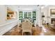Elegant dining area with hardwood floors, built-in shelving, a table with seating, and a view to the kitchen at 3382 Habersham Rd, Atlanta, GA 30305