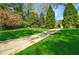 Long driveway leading to a traditional home, surrounded by mature trees and expansive green lawn at 3382 Habersham Rd, Atlanta, GA 30305