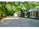 Exterior view of the home with a long driveway leading to a three-car garage at 3382 Habersham Rd, Atlanta, GA 30305