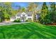 Classic two-story home featuring a lush green lawn and traditional architectural design elements at 3382 Habersham Rd, Atlanta, GA 30305