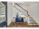 Elegant foyer features staircase, a stylish chest with decor, and hardwood floors at 3382 Habersham Rd, Atlanta, GA 30305
