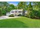 Beautifully landscaped two-story home with a circular driveway and lush green lawn at 3382 Habersham Rd, Atlanta, GA 30305