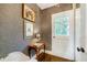 Hallway featuring wallpapered walls, dark wood floors, and a window at 3382 Habersham Rd, Atlanta, GA 30305
