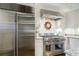 Gourmet kitchen featuring a stainless steel range, herringbone backsplash, granite countertops, and a stainless refrigerator at 3382 Habersham Rd, Atlanta, GA 30305