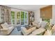 Bright living area featuring comfortable seating, bamboo blinds, and a glass door leading to a balcony at 3382 Habersham Rd, Atlanta, GA 30305