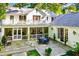 Elevated view of the beautiful outdoor patio with stone flooring, seating, a screened porch, and the home's exterior at 3382 Habersham Rd, Atlanta, GA 30305