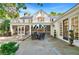 Beautiful outdoor patio with stone flooring, seating area, screened porch, and lush landscaping at 3382 Habersham Rd, Atlanta, GA 30305