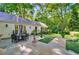 Outdoor stone patio with dining table surrounded by manicured backyard at 3382 Habersham Rd, Atlanta, GA 30305