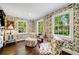 Inviting sitting area featuring patterned wallpaper, hardwood floors, and multiple windows at 3382 Habersham Rd, Atlanta, GA 30305
