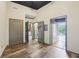 Bright bedroom featuring wood floors, neutral walls, and doors leading to a balcony and other rooms at 3400 Malone Dr # 303, Atlanta, GA 30341