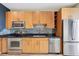 Well-equipped kitchen with stainless steel appliances, black granite countertops, and wood cabinets at 3400 Malone Dr # 303, Atlanta, GA 30341