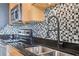 Close up shot of kitchen features granite countertops, tiled backsplash, and stainless steel appliances at 3400 Malone Dr # 303, Atlanta, GA 30341