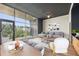 Bright living area featuring hardwood floors, oversized windows, and balcony access at 3400 Malone Dr # 303, Atlanta, GA 30341