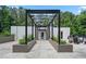 Inviting pool entrance featuring a modern pergola, lush greenery, and outdoor seating at 3400 Malone Dr # 303, Atlanta, GA 30341