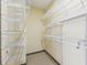 Organized walk-in closet with multiple white shelves and hanging rods for efficient storage at 3400 Malone Dr # 303, Atlanta, GA 30341