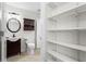 Bathroom featuring a sink, toilet and cabinet, plus a large storage area with shelves at 4108 Gray Birch Ln, Duluth, GA 30096
