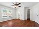 Bedroom featuring hardwood floors, a ceiling fan, a view of the bathroom, and a window at 4108 Gray Birch Ln, Duluth, GA 30096