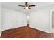 Bedroom featuring hardwood floors, a ceiling fan, and a view of the bathroom at 4108 Gray Birch Ln, Duluth, GA 30096
