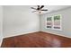 Bedroom featuring hardwood floors, a ceiling fan, and natural light from the window at 4108 Gray Birch Ln, Duluth, GA 30096