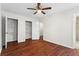 Bedroom with hardwood floors, a ceiling fan, and closet with shelving at 4108 Gray Birch Ln, Duluth, GA 30096