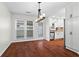 Dining room featuring hardwood floors, white cabinets and large windows at 4108 Gray Birch Ln, Duluth, GA 30096