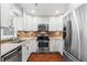 Updated kitchen featuring stainless steel appliances, granite counters, and white cabinets at 4108 Gray Birch Ln, Duluth, GA 30096