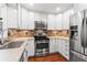 Bright kitchen with stainless steel appliances, white cabinets, and granite countertops at 4108 Gray Birch Ln, Duluth, GA 30096