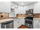 Updated kitchen featuring stainless steel appliances, granite counters, and wooden cabinets at 4108 Gray Birch Ln, Duluth, GA 30096