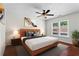 Comfortable bedroom with a ceiling fan, large window, and stylish decor at 4108 Gray Birch Ln, Duluth, GA 30096