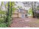 Spacious backyard with mature trees, rear home elevation and minimal grass at 7113 Ambercrest Ct, Austell, GA 30168