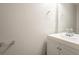 Clean half bathroom features a sleek vanity, a mirror, and neutral-toned walls at 7113 Ambercrest Ct, Austell, GA 30168