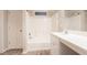 Bright bathroom features a shower-tub combination, white vanity, and modern fixtures at 7113 Ambercrest Ct, Austell, GA 30168