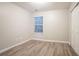 Neutral bedroom with hardwood floors, a window with blinds, and a closet at 7113 Ambercrest Ct, Austell, GA 30168
