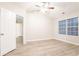Bright bedroom with wood floors, vaulted ceiling, and natural light from a large window at 7113 Ambercrest Ct, Austell, GA 30168