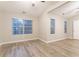 Bright bedroom with vaulted ceilings, wood-look floors, and natural light from multiple windows at 7113 Ambercrest Ct, Austell, GA 30168
