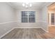 Serene dining room featuring light gray flooring and natural light, ideal for cozy meals at 7113 Ambercrest Ct, Austell, GA 30168